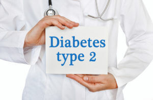 A medical doctor holding a Type 2 Diabetes card.